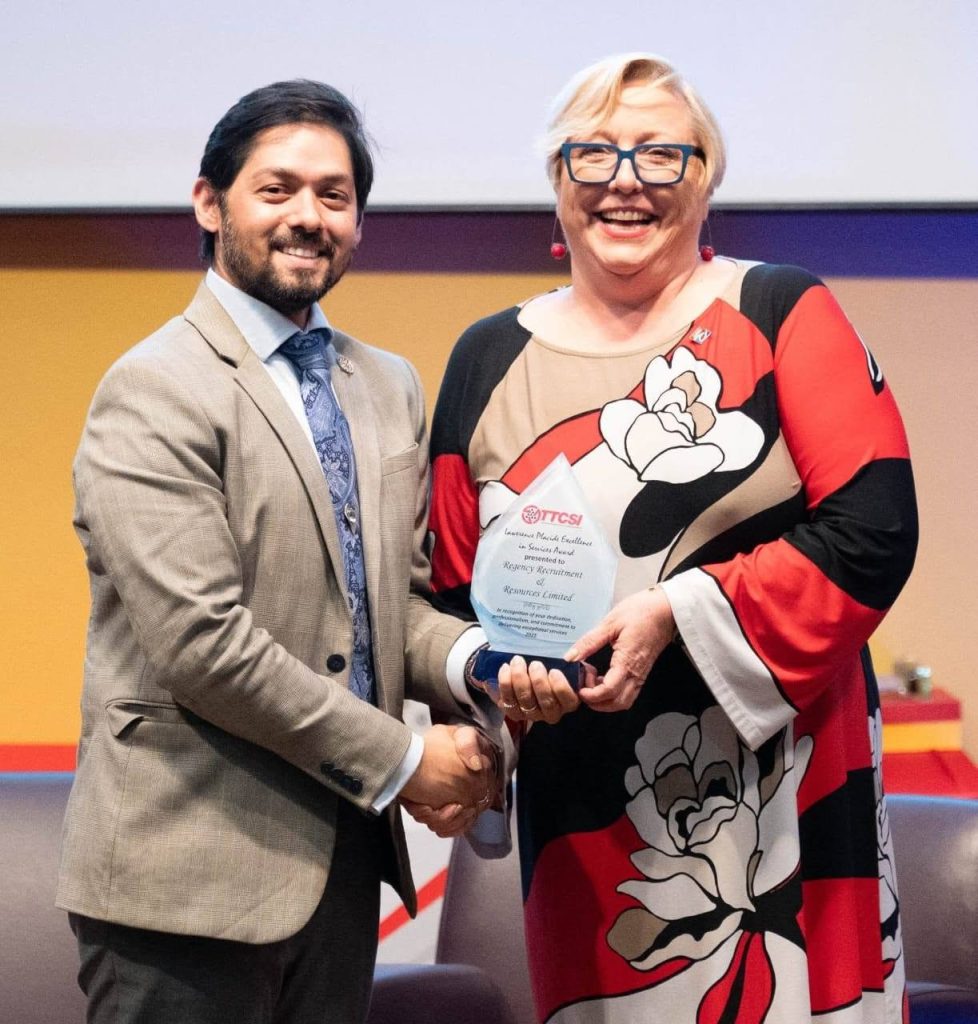 Lara Quentrall-Thomas, Chairman of Regency Recruitment & Resources Ltd, receives the Lawrence Placide award from Rudolph Hanamji, CEO of the Private Sector Organisation of Trinidad and Tobago (PSOTT).